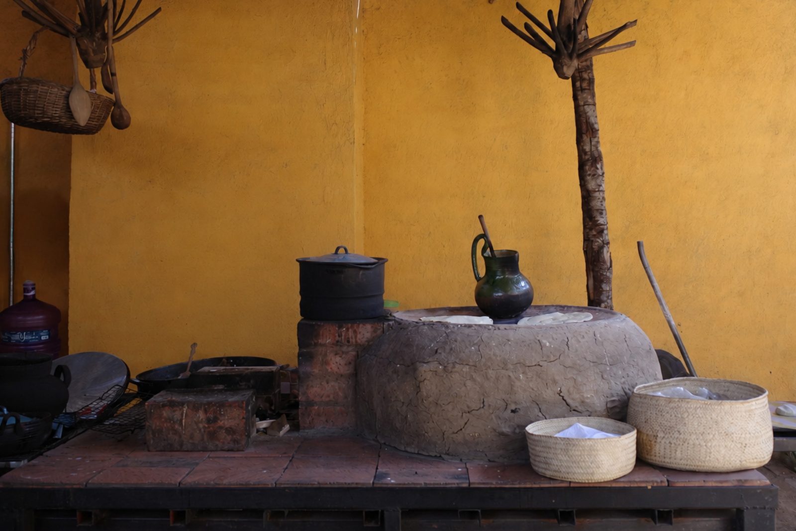 A traditional Mexican kitchen: tortillas are cooked on a comal, the round clay griddle set atop an earthen hearth